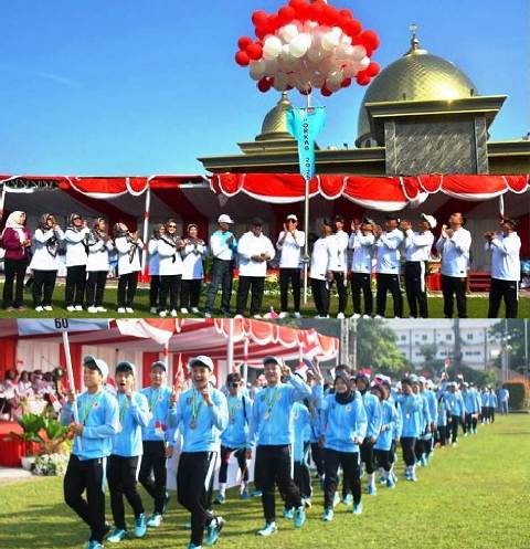 Bupati Jombang Abah Warsubi dan Gus Wabup Jombang memotong- melepas ikatan balon sebagai tanda PORKAB dalam lingkup OPD Pemkab Jombang dimulai (foto atas) sedangkan foto bawah kontingen PORPROV KONI Kabupaten Jombang hadir mengukuti defile di lapangan Pemkab Jombang, Kamis (7/8/2025). 