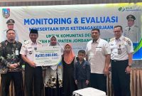 Kepala Cabang BPJS Ketenagakerjaan Kabupaten Jombang Ibrahim Hadi Wibowo (kiri) mendapingi Sekdakab Jombang Agus Purnomo, S.H., M.Si (kedua dari kiri) menyerahkan klaim jaminan kecelakaan kerja dan beasiswa kepada M Nastain (almarhum), seorang RT Desa Tugusumberjo, Kecamatan Peterongan, Kabupaten Jombang.    